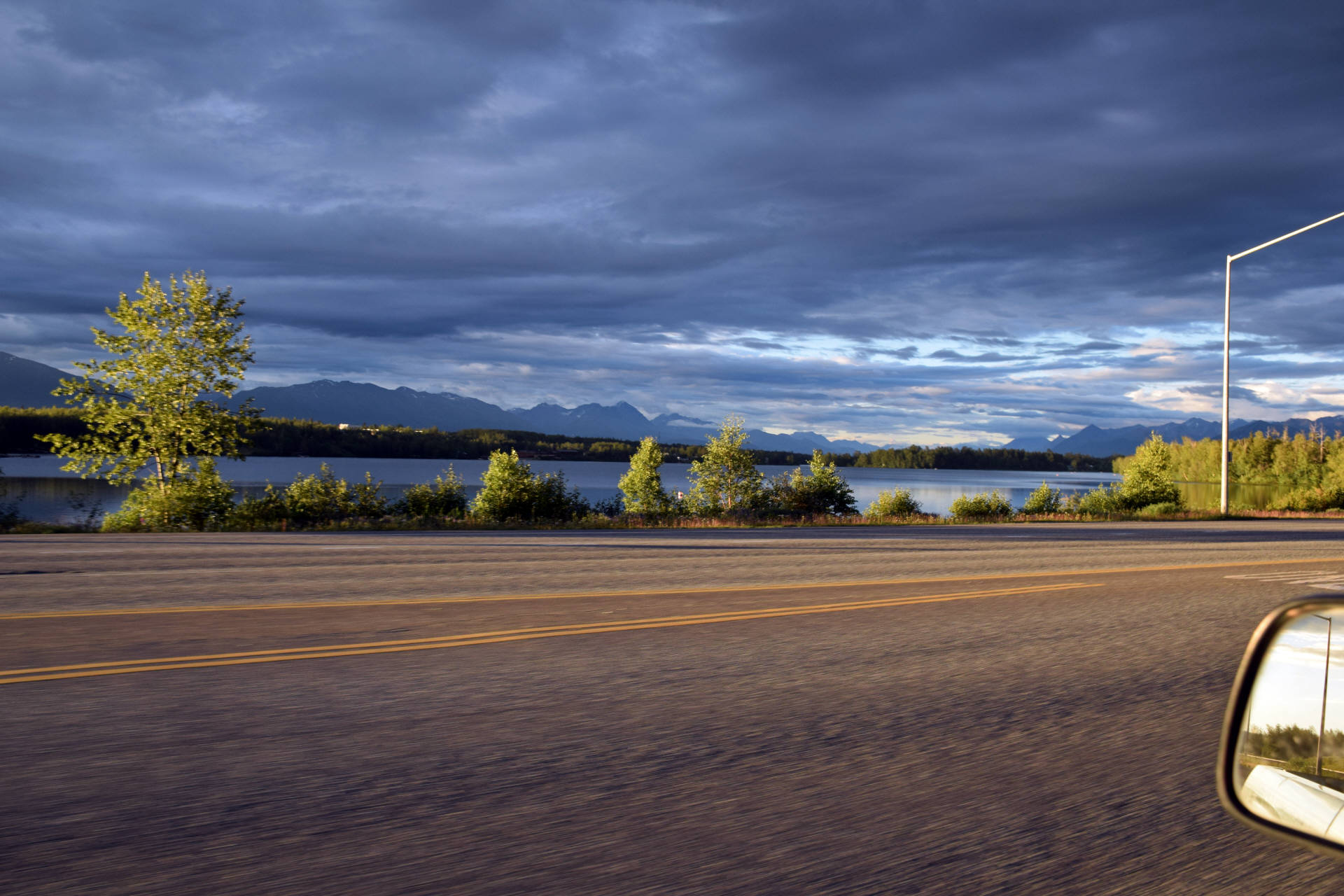 View to Alaska Range and Wasilla lake from Parks Highway in Wasilla, Alaska, on sunset. Photo: Fyodor Soloview.